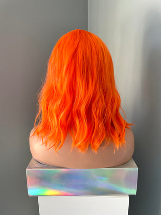 "Rae" - Short Neon Orange Wig With Bangs