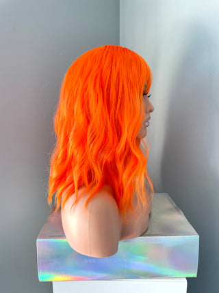 "Rae" - Short Neon Orange Wig With Bangs