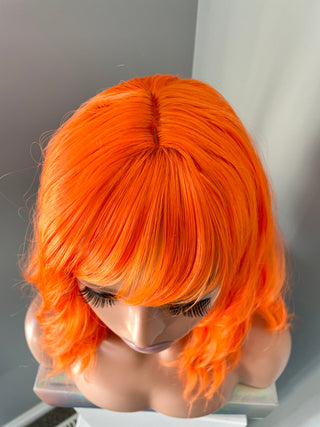 "Rae" - Short Neon Orange Wig With Bangs