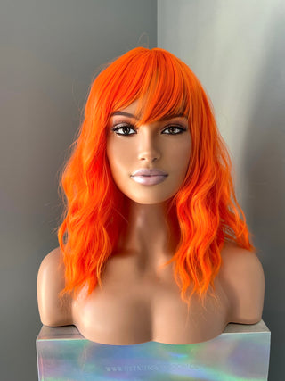 "Rae" - Short Neon Orange Wig With Bangs