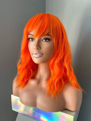 "Rae" - Short Neon Orange Wig With Bangs